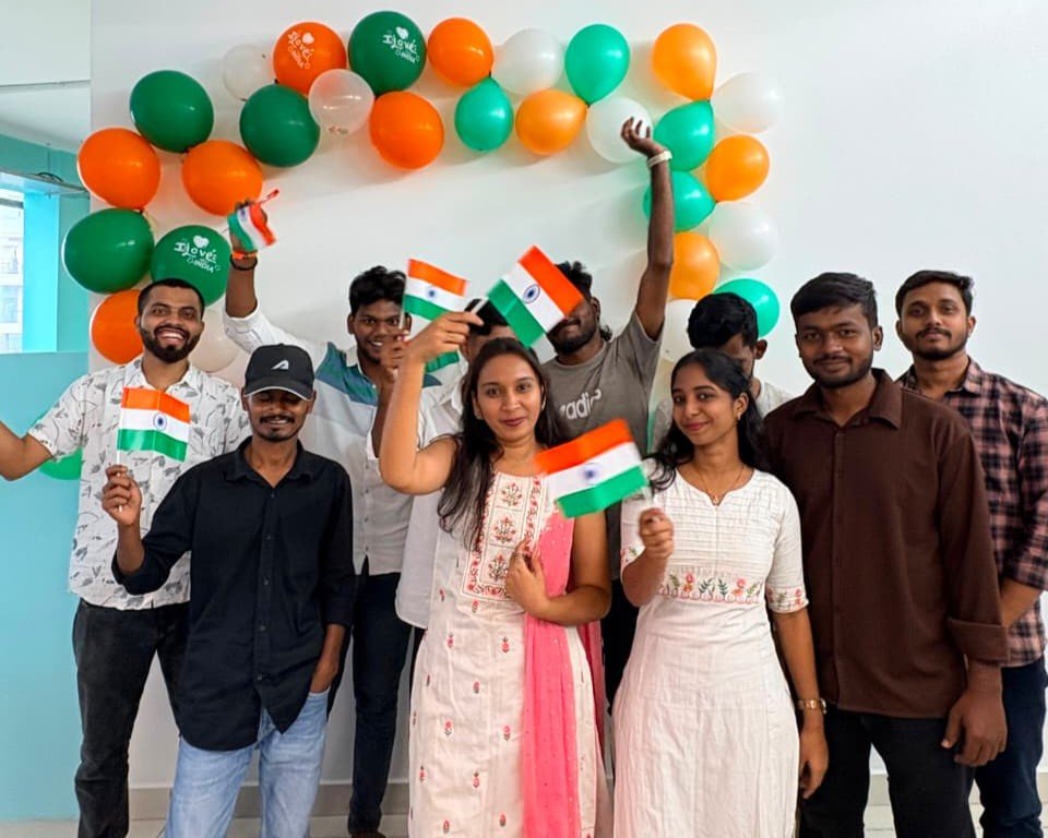 Team celebrating Independence Day with Indian flags and tricolour balloons